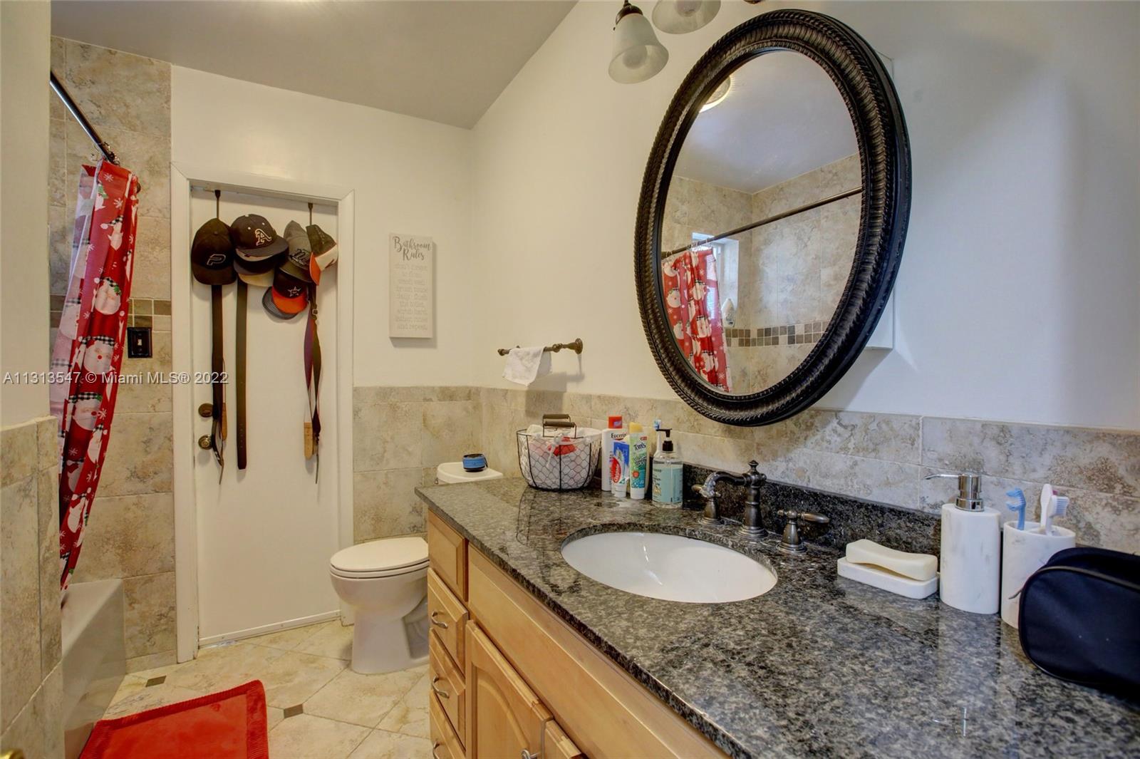 6681 Peters Road Plantation, FL 33317 - Photo 14 of 27 a bathroom with a granite countertop double vanity sink mirror and toilet