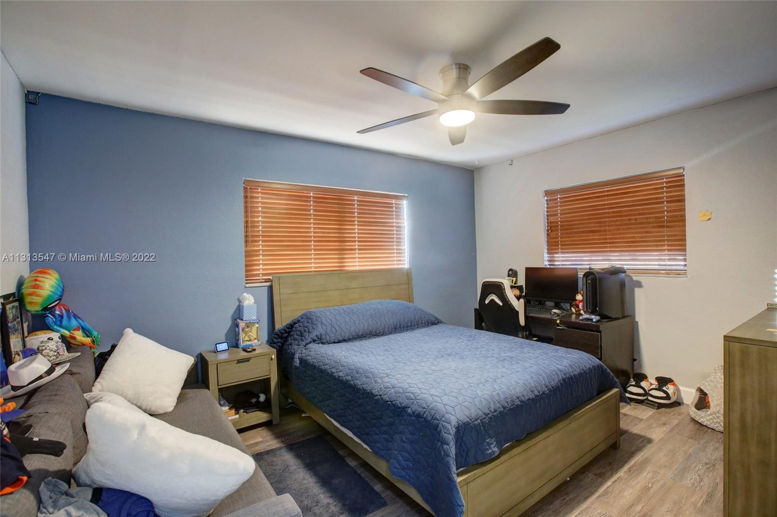 6681 Peters Road Plantation, FL 33317 - Photo 16 of 27 a bedroom with a bed and wooden floor