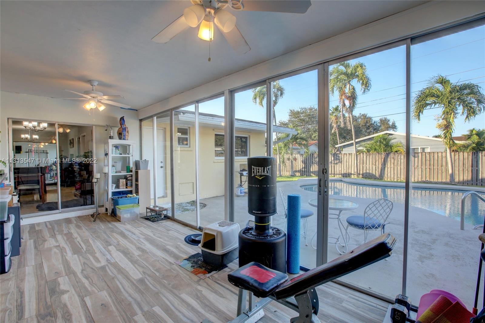 6681 Peters Road Plantation, FL 33317 - Photo 18 of 27 a very nice looking room with a large window and wooden floor