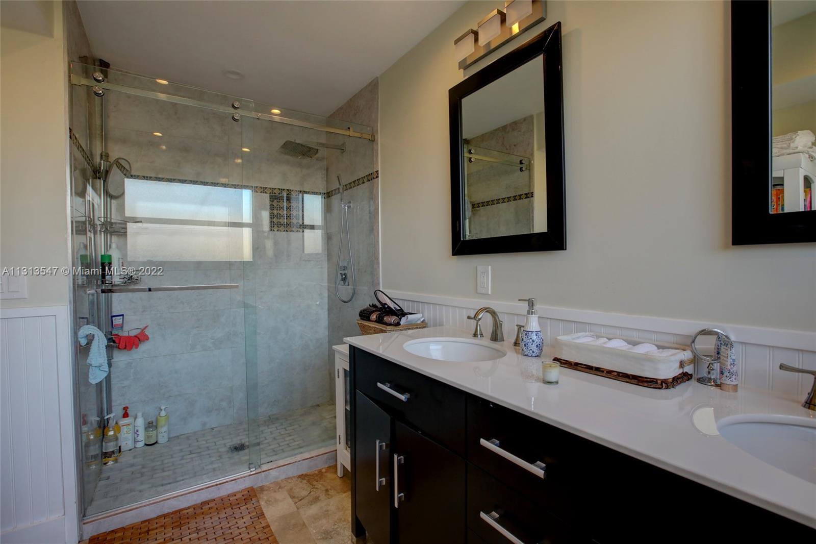 6681 Peters Road Plantation, FL 33317 - Photo 19 of 27 a bathroom with a sink and a mirror