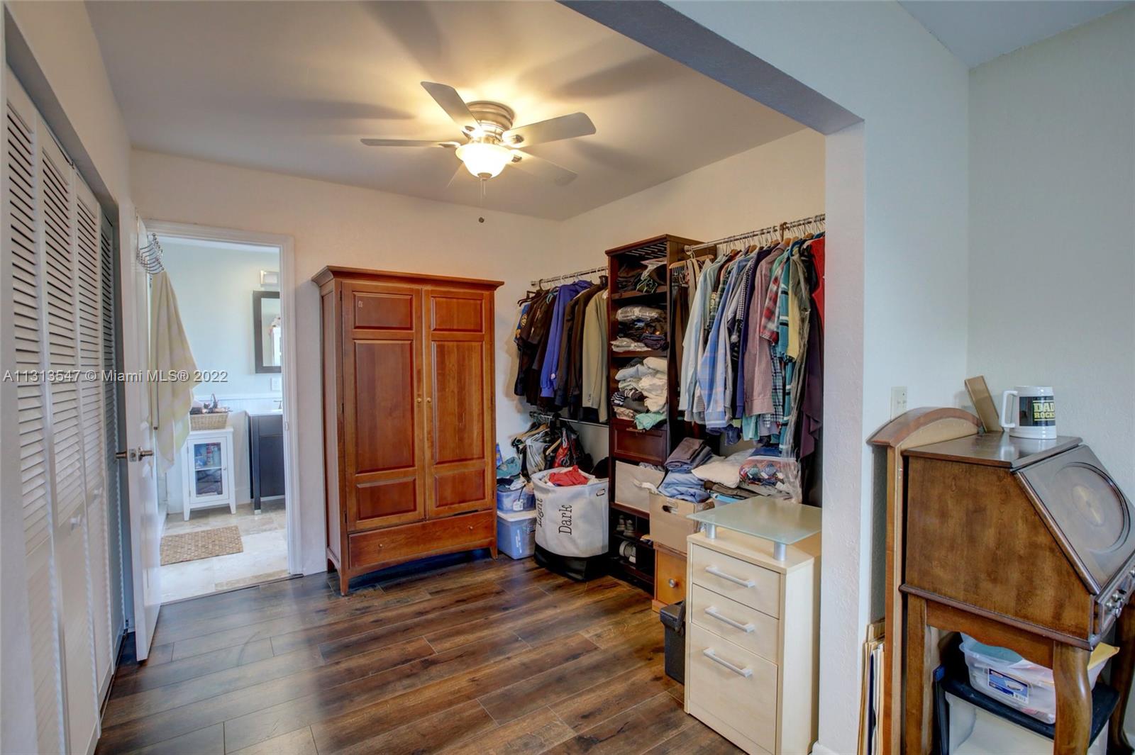 6681 Peters Road Plantation, FL 33317 - Photo 20 of 27 a view of a bedroom with workspace and mirror