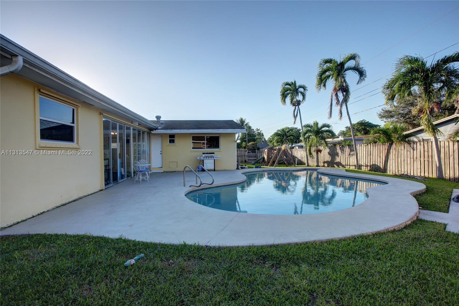 6681 Peters Road Plantation, FL 33317 - Photo 25 of 27 swimming pool view with a garden space