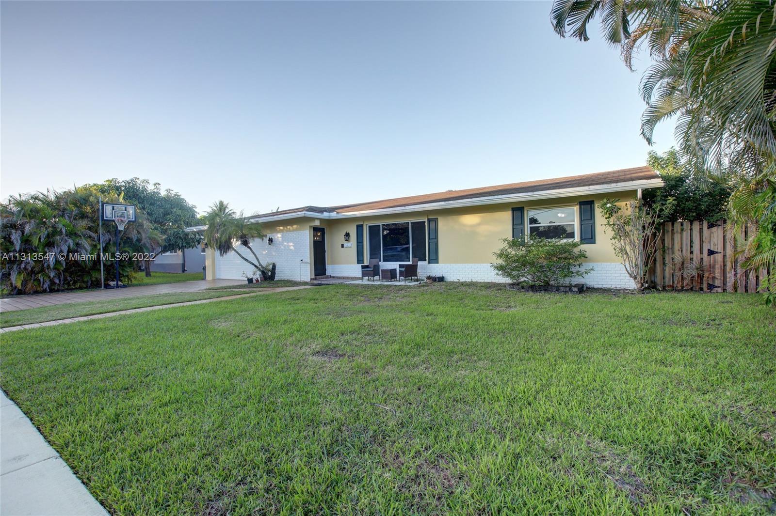 6681 Peters Road Plantation, FL 33317 - Photo 3 of 27 a view of house with outdoor space and garden