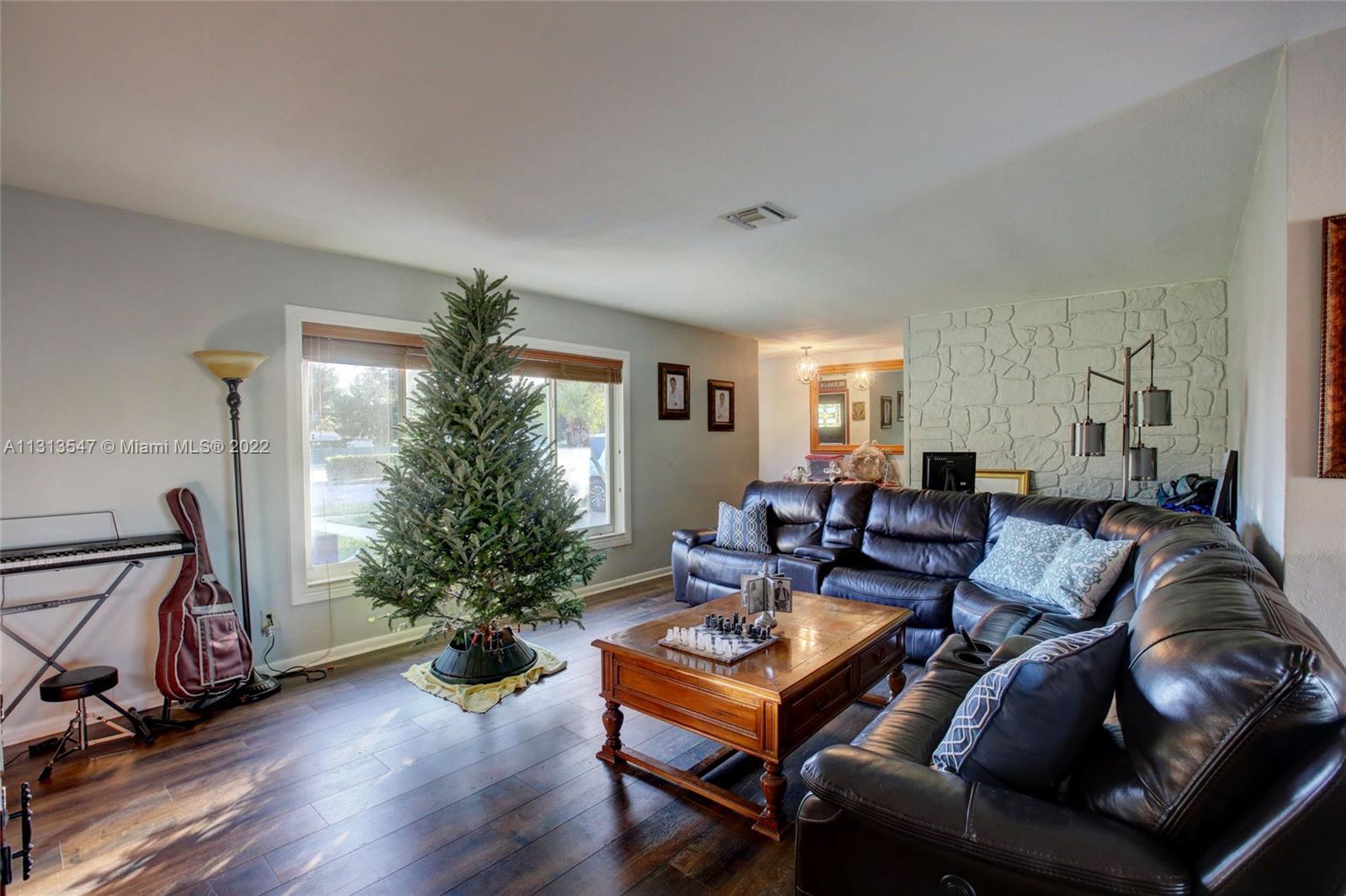 6681 Peters Road Plantation, FL 33317 - Photo 4 of 27 a living room with furniture and a potted plant