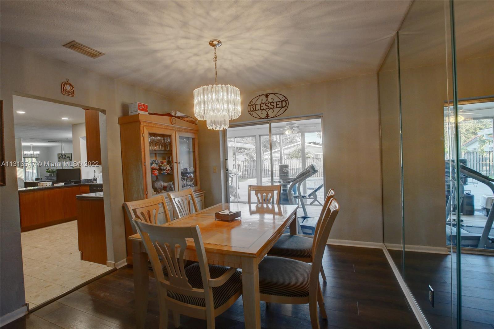 6681 Peters Road Plantation, FL 33317 - Photo 7 of 27 a view of a dining room with furniture window and wooden floor