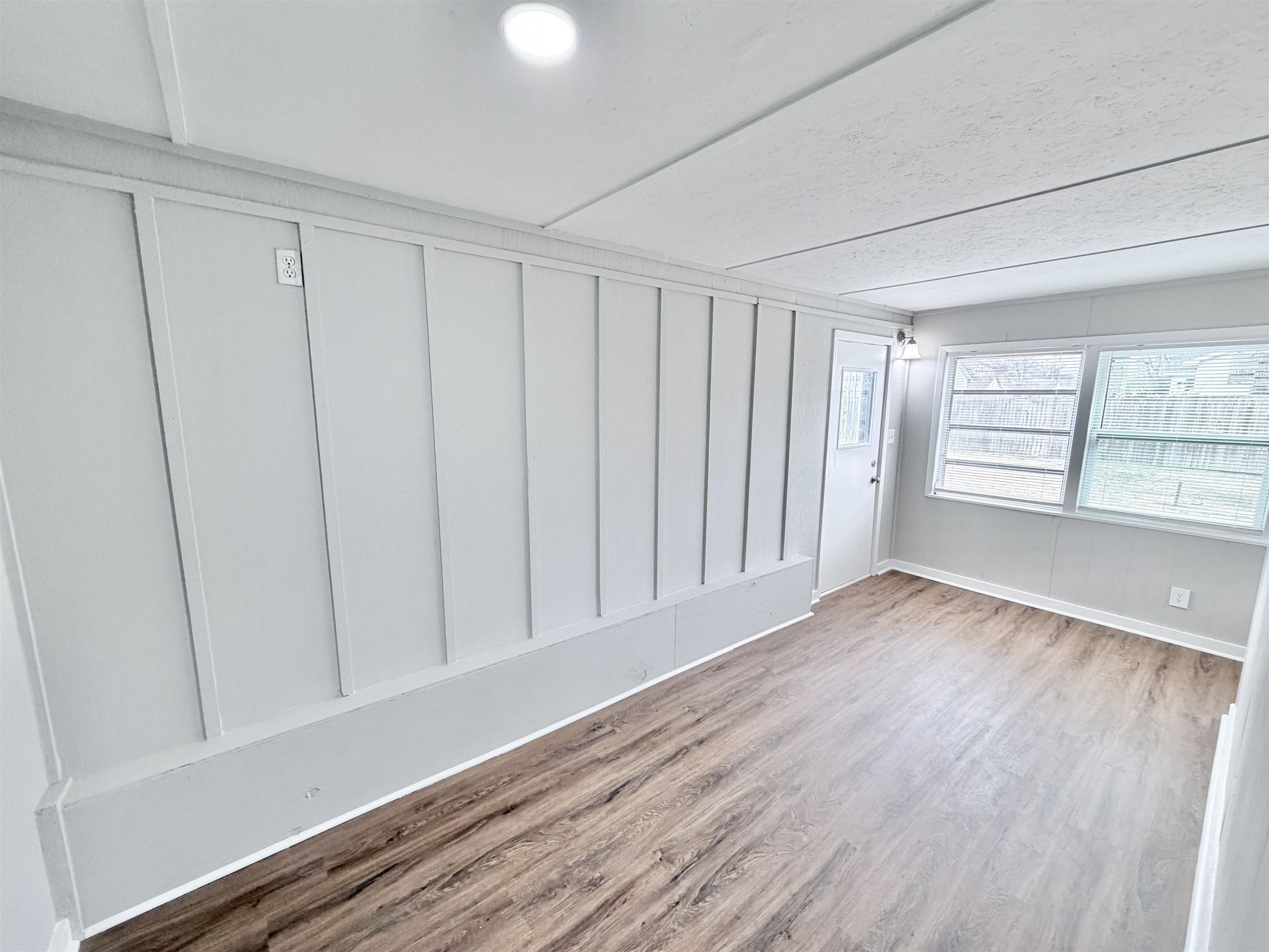 7830 Quito Road Millington, TN 38053 - Photo 11 of 26 a view of an empty room with a window and hardwood floor