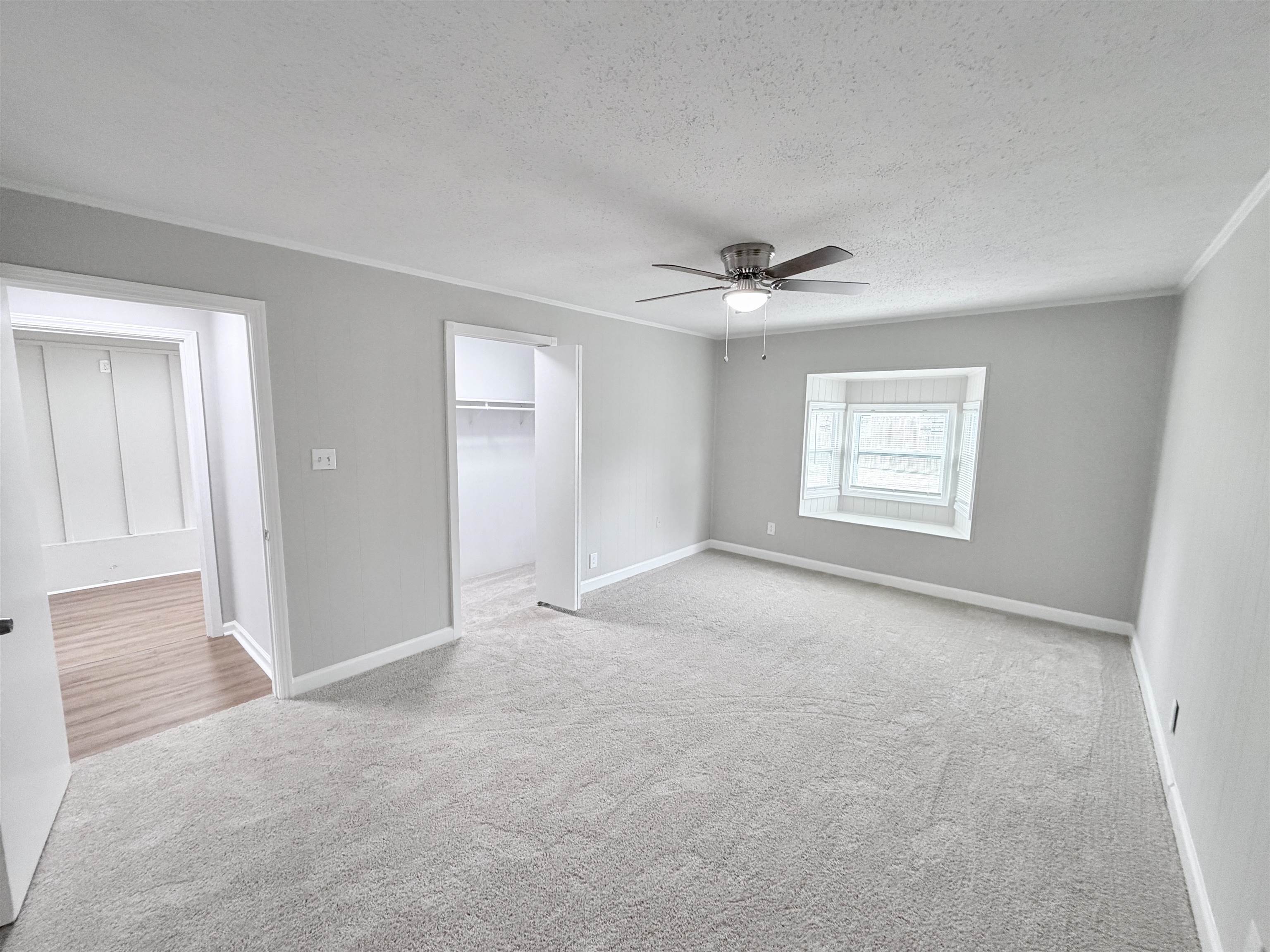 7830 Quito Road Millington, TN 38053 - Photo 13 of 26 an empty room with windows and ceiling fan