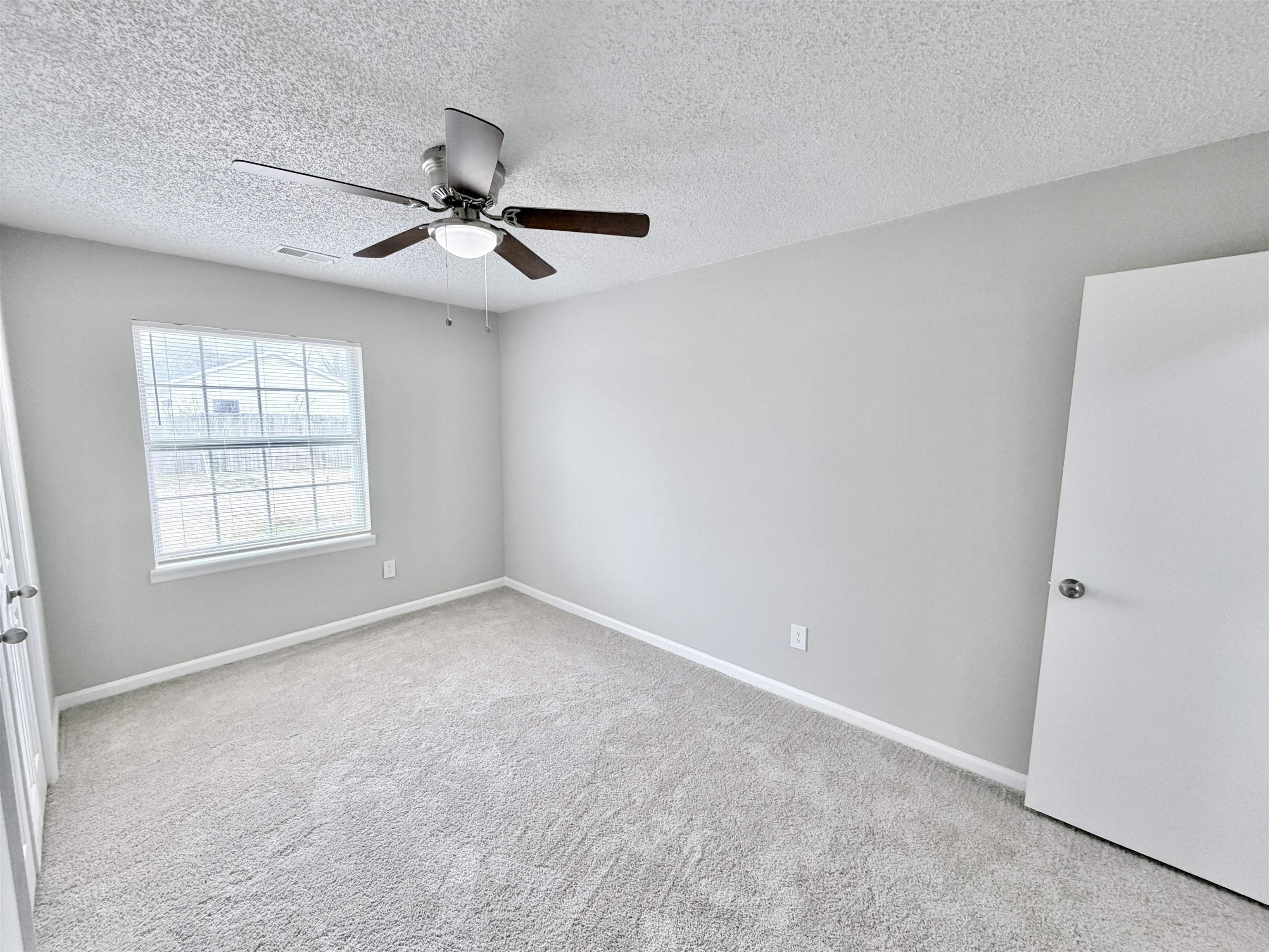 7830 Quito Road Millington, TN 38053 - Photo 15 of 26 an empty room with windows and fan
