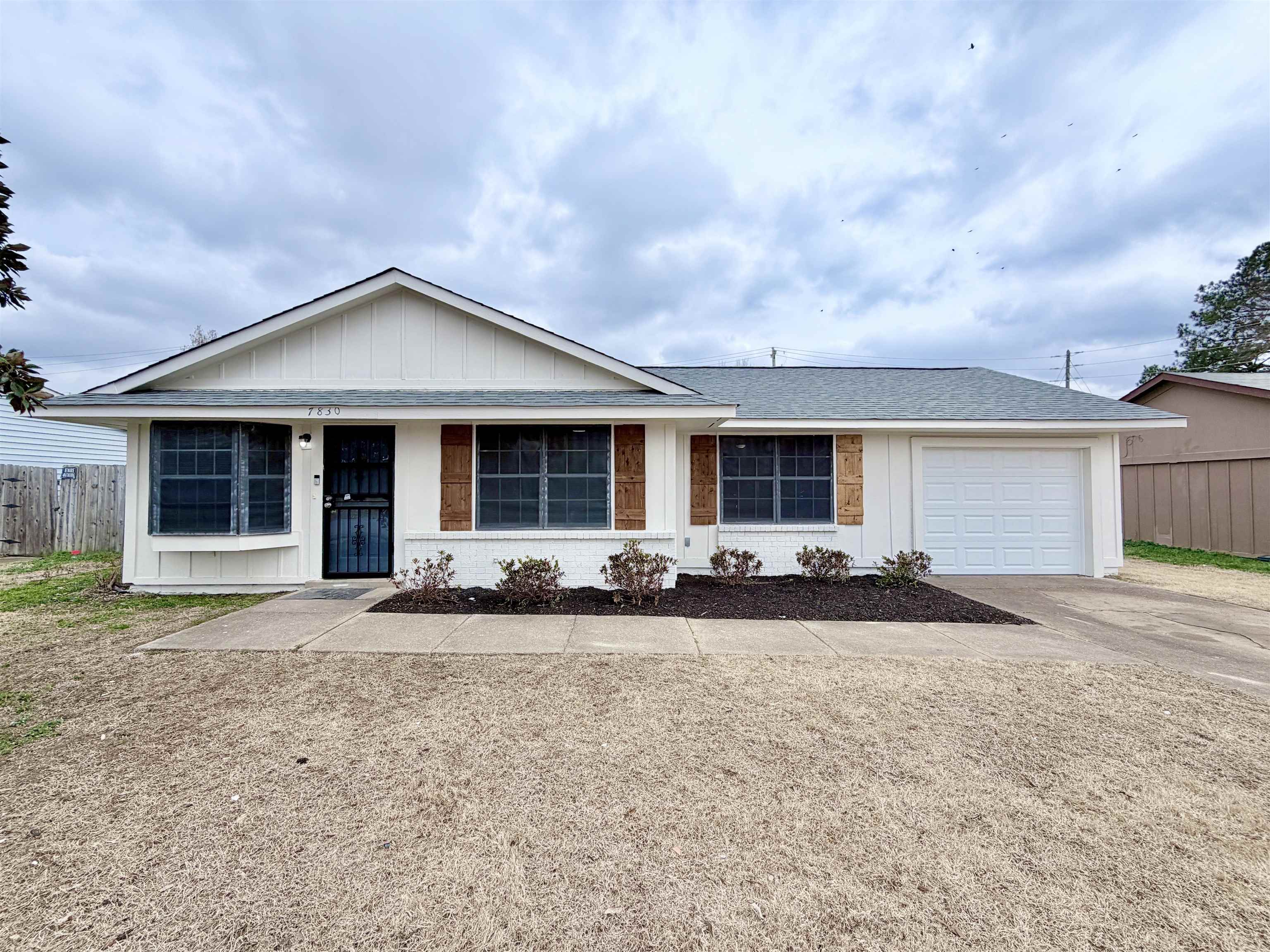 7830 Quito Road Millington, TN 38053 - Photo 2 of 26 a front view of a house with a yard and garage