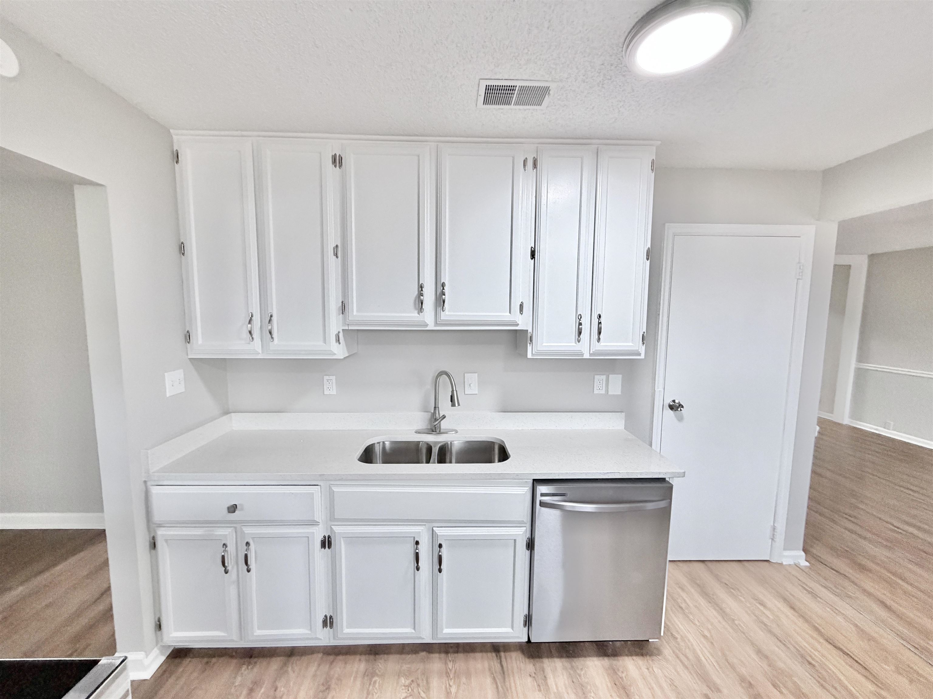 7830 Quito Road Millington, TN 38053 - Photo 5 of 26 a kitchen with granite countertop white cabinets and white appliances