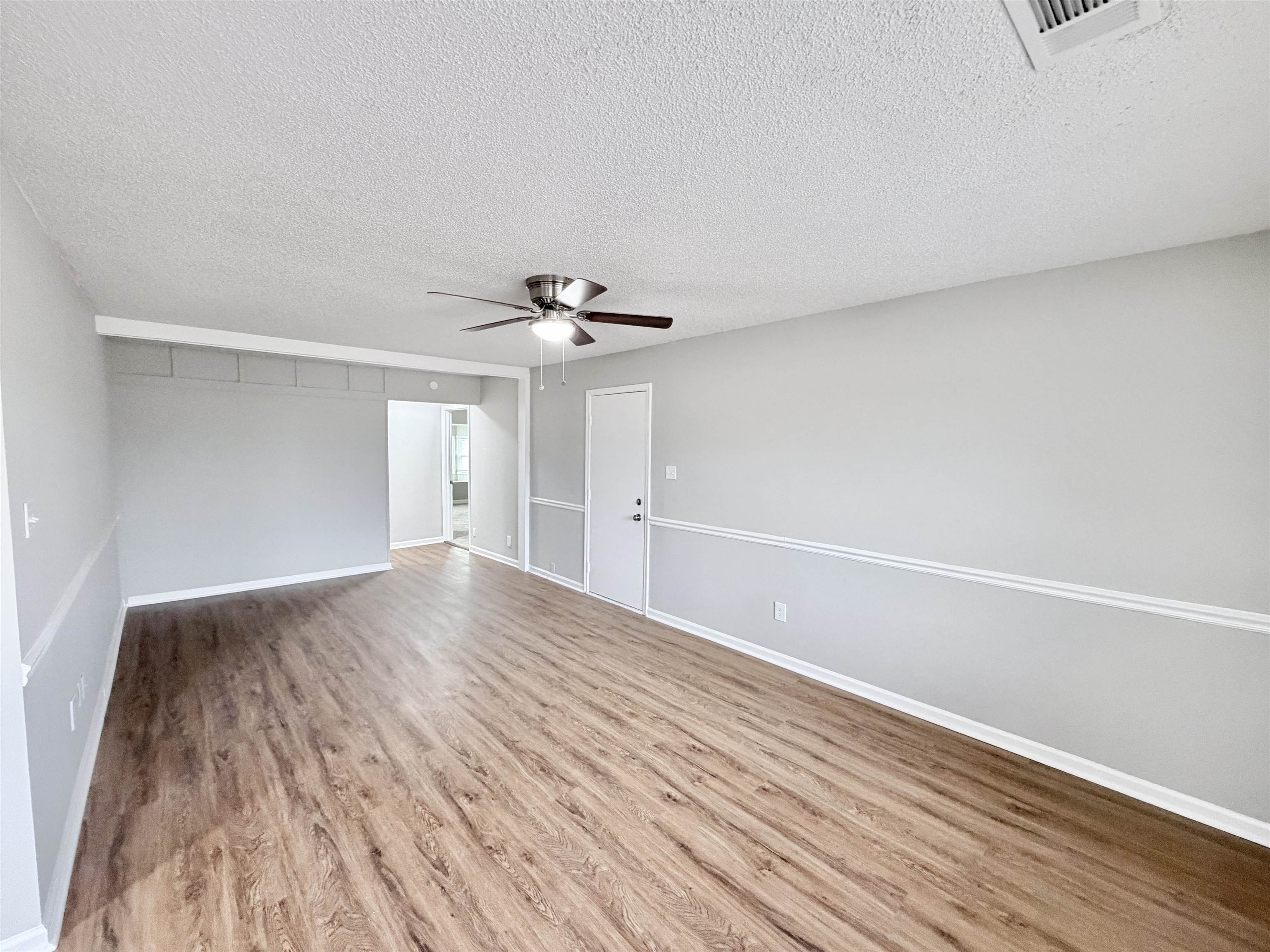 7830 Quito Road Millington, TN 38053 - Photo 8 of 26 a view of an empty room with wooden floor