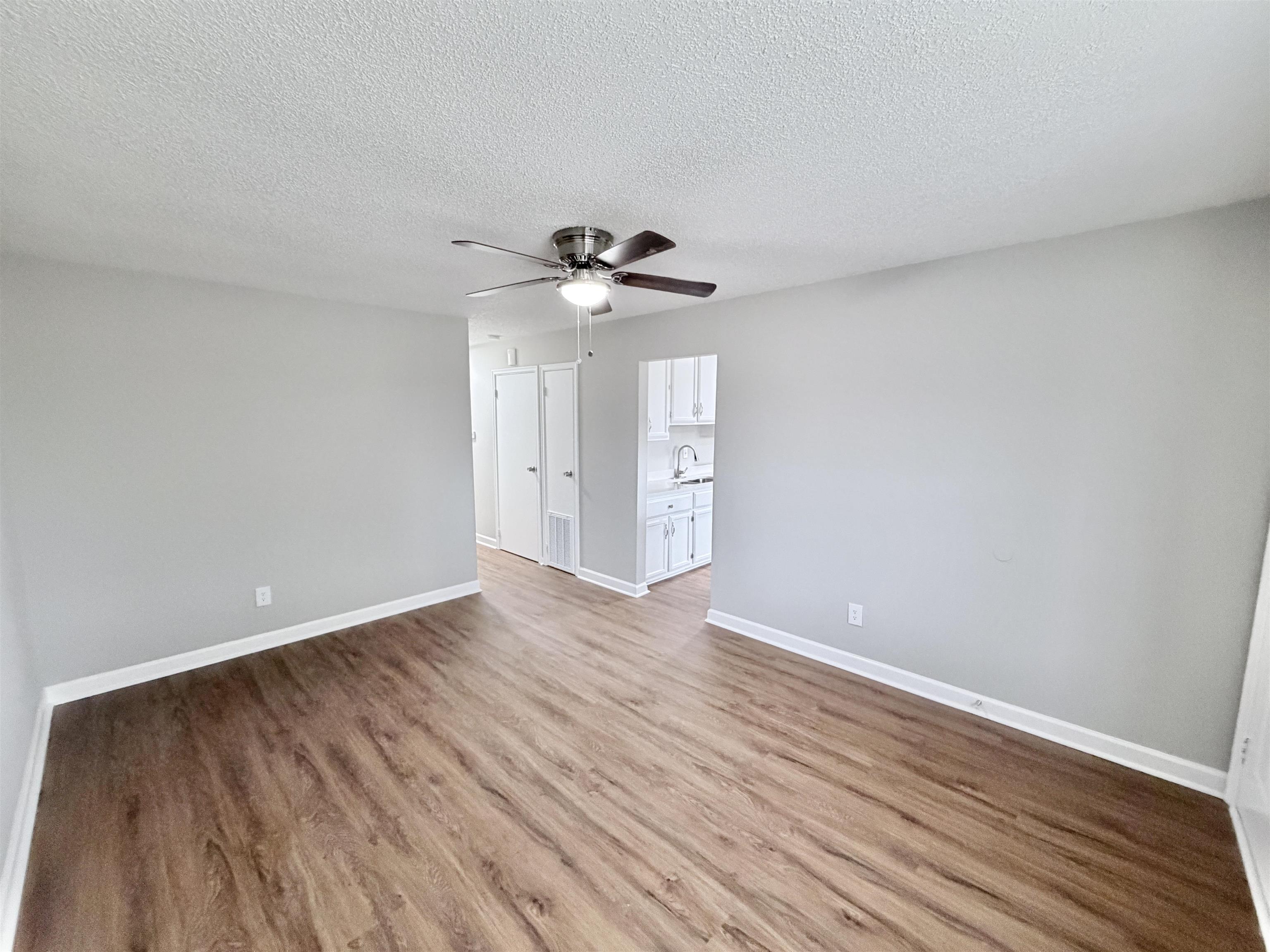 7830 Quito Road Millington, TN 38053 - Photo 9 of 26 a view of an empty room with a window and wooden floor
