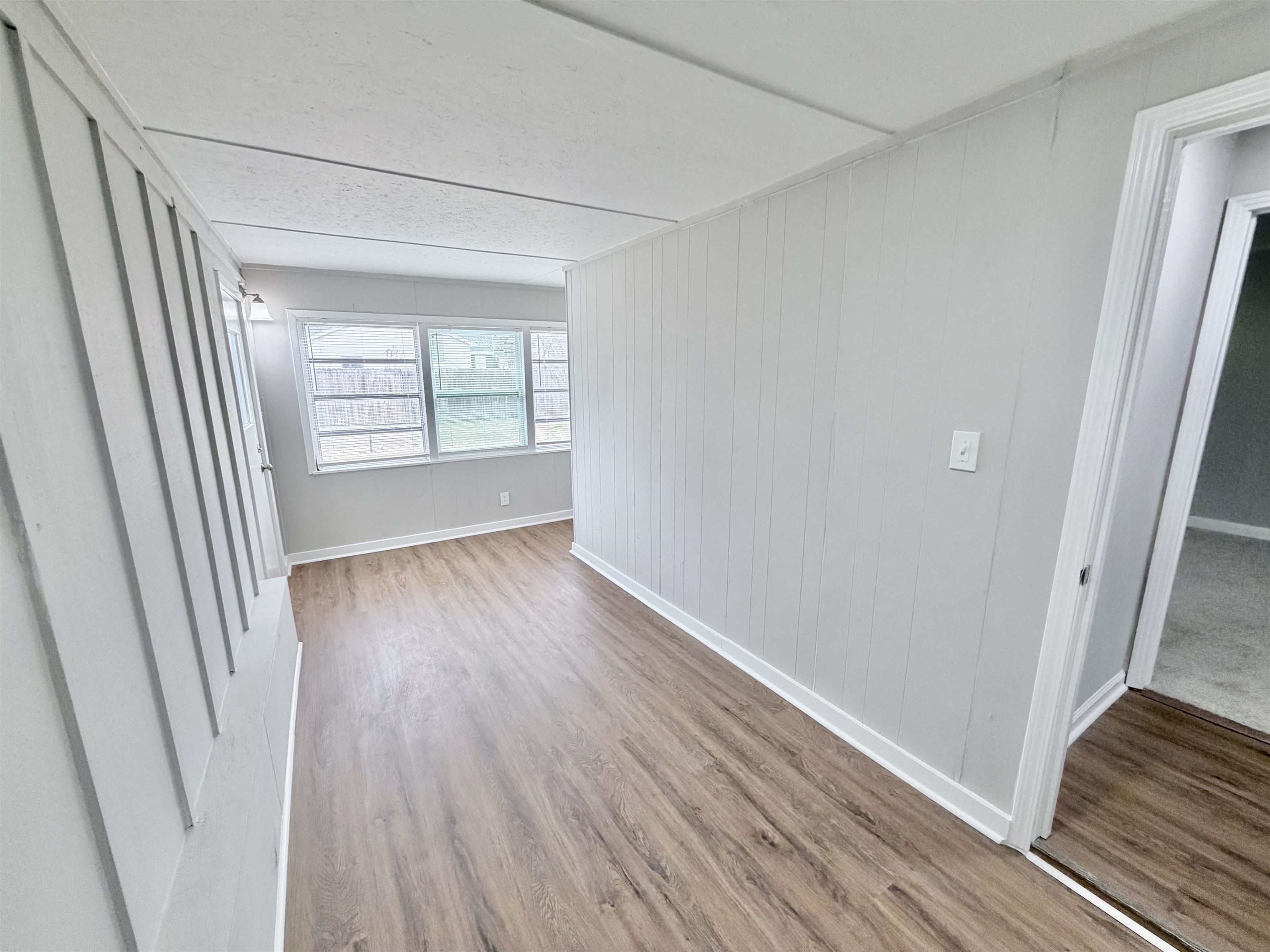 7830 Quito Road Millington, TN 38053 - Photo 10 of 26 an empty room with wooden floor and windows