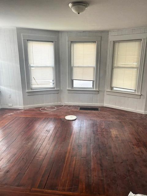 82 North Hamilton Street, Unit 1 Poughkeepsie, NY 12601 - Photo 3 of 8 an empty room with wooden floor and windows