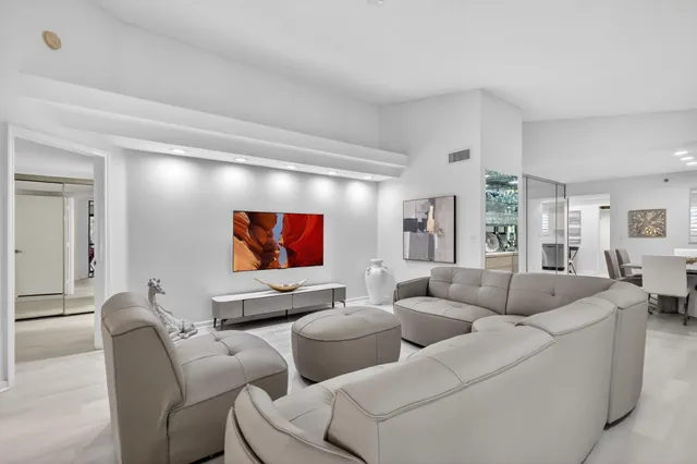 a living room with furniture and a floor to ceiling window