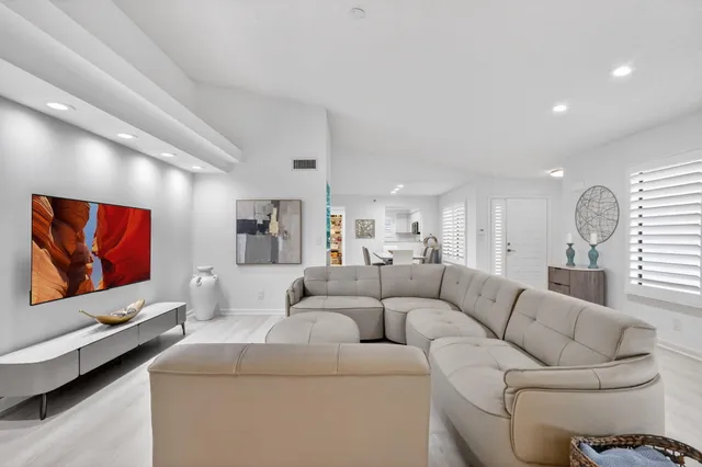 a living room with furniture and a floor to ceiling window