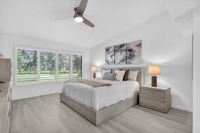 a view of a patio with a table and chairs and potted plants