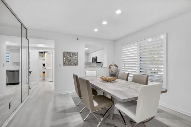 a dining room with furniture and wooden floor