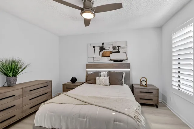 an aerial view of residential houses with outdoor space and trees