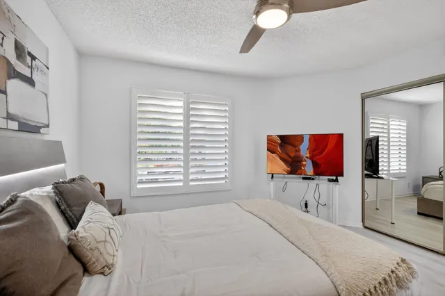 an aerial view of a house with a garden and lake view
