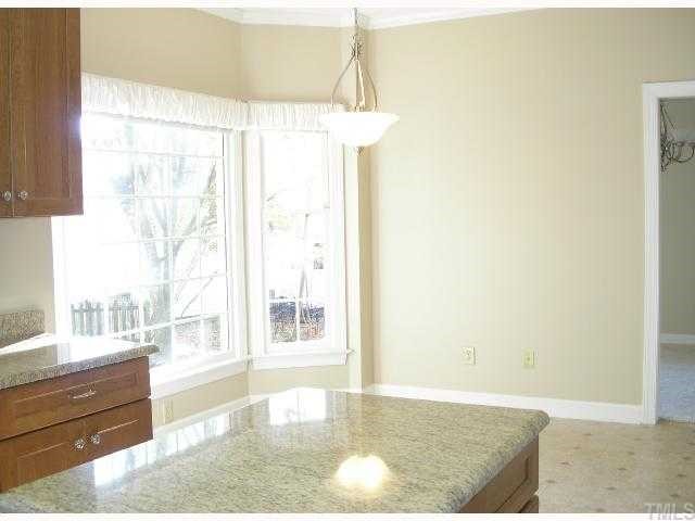 5405 Islehurst Court Raleigh, NC 27613 - Photo 3 of 12 a view of a room with wooden floor and windows