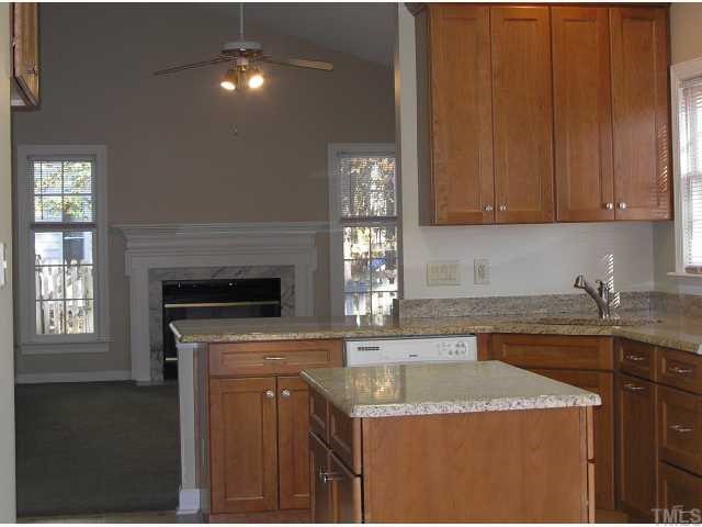 5405 Islehurst Court Raleigh, NC 27613 - Photo 5 of 12 a kitchen with granite countertop a sink a stove and cabinets