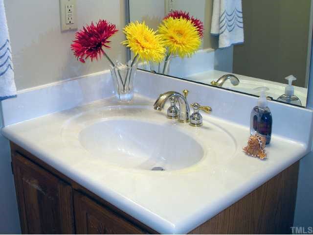 5405 Islehurst Court Raleigh, NC 27613 - Photo 9 of 12 a bathroom with a sink a vanity and a mirror