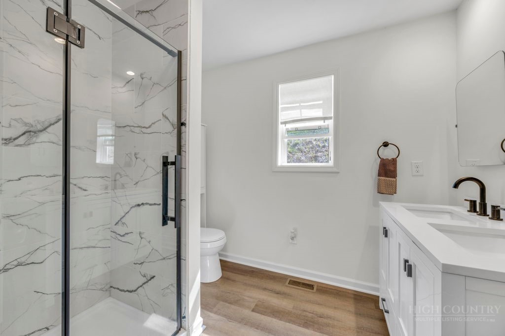 656 Mulatto Mountain Road West Jefferson, NC 28694 - Photo 25 of 35 a bathroom with a shower and sink