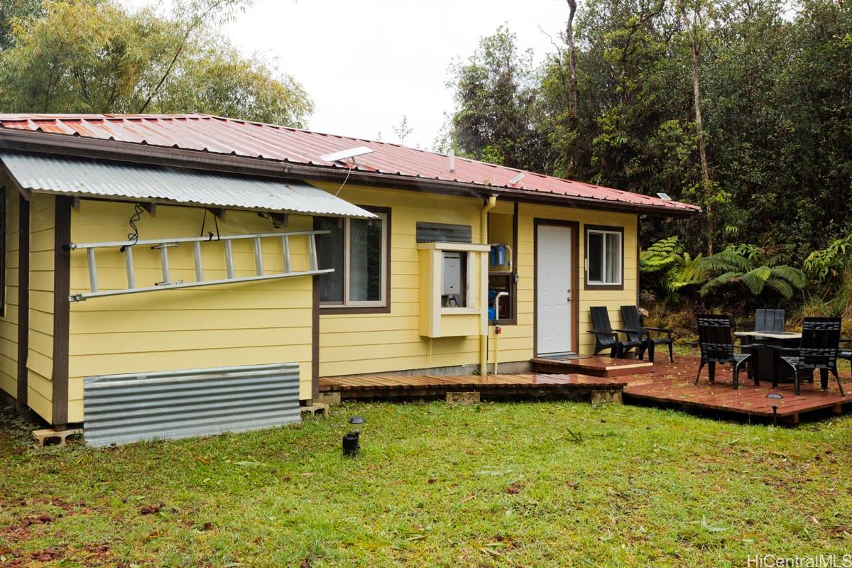 18-2274 Laulea Road Volcano, HI 96785 - Photo 13 of 15 Exterior view highlighting the home’s placement within a lush, forested setting on the Big Island of Hawai‘i