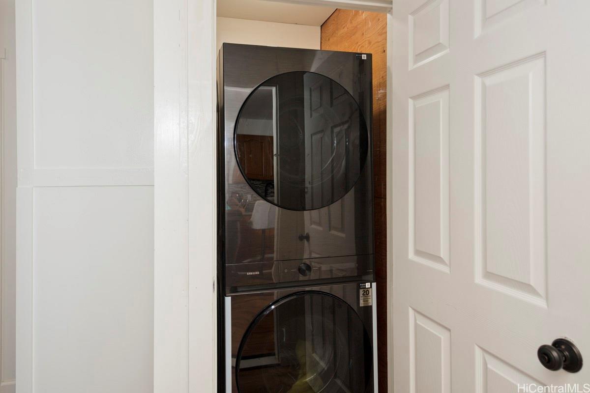 18-2274 Laulea Road Volcano, HI 96785 - Photo 8 of 15 Stacked washer and dryer included, adding convenience to this turn-key Hawai‘i Island home