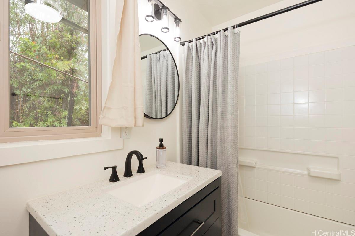 18-2274 Laulea Road Volcano, HI 96785 - Photo 9 of 15 Bathroom with modern vanity, mirror, and natural light, offering clean and functional design