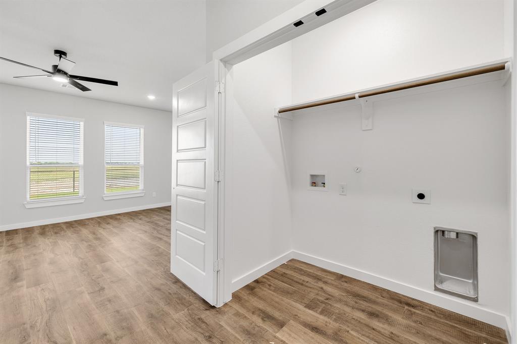7050-7052 Guilford Road Midlothian, TX 76065 - Photo 11 of 36 a view of an empty room with a window and wooden floor