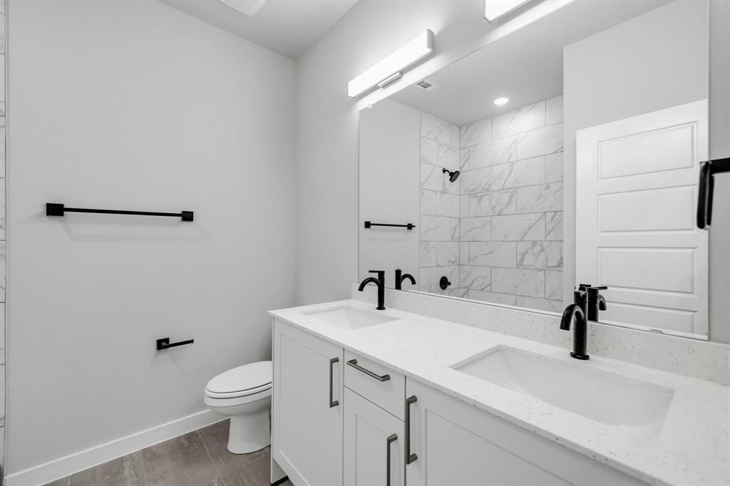 7050-7052 Guilford Road Midlothian, TX 76065 - Photo 15 of 36 a bathroom with a sink a toilet and shower