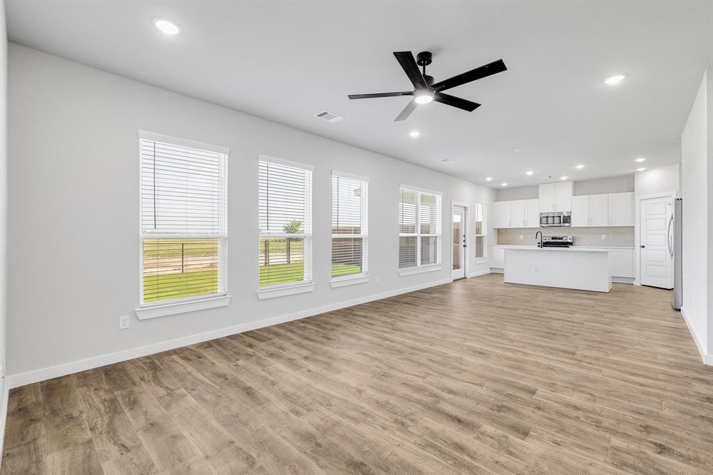 7050-7052 Guilford Road Midlothian, TX 76065 - Photo 26 of 36 a view of an empty room with a window and a kitchen