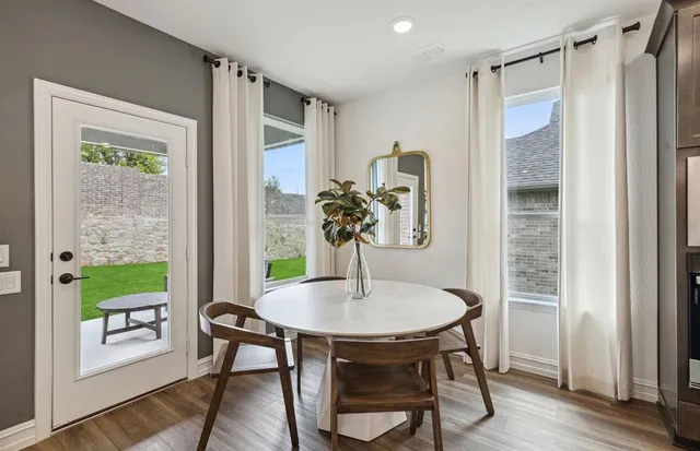 a view of a dining room with furniture window and wooden floor