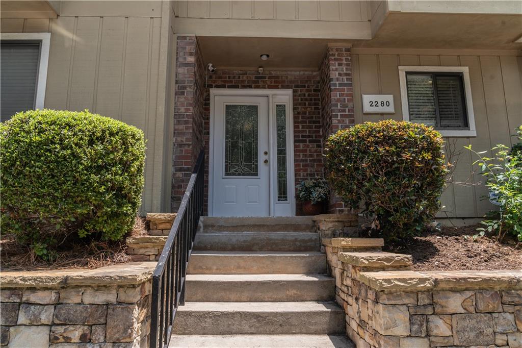 a front view of a house with potted plants