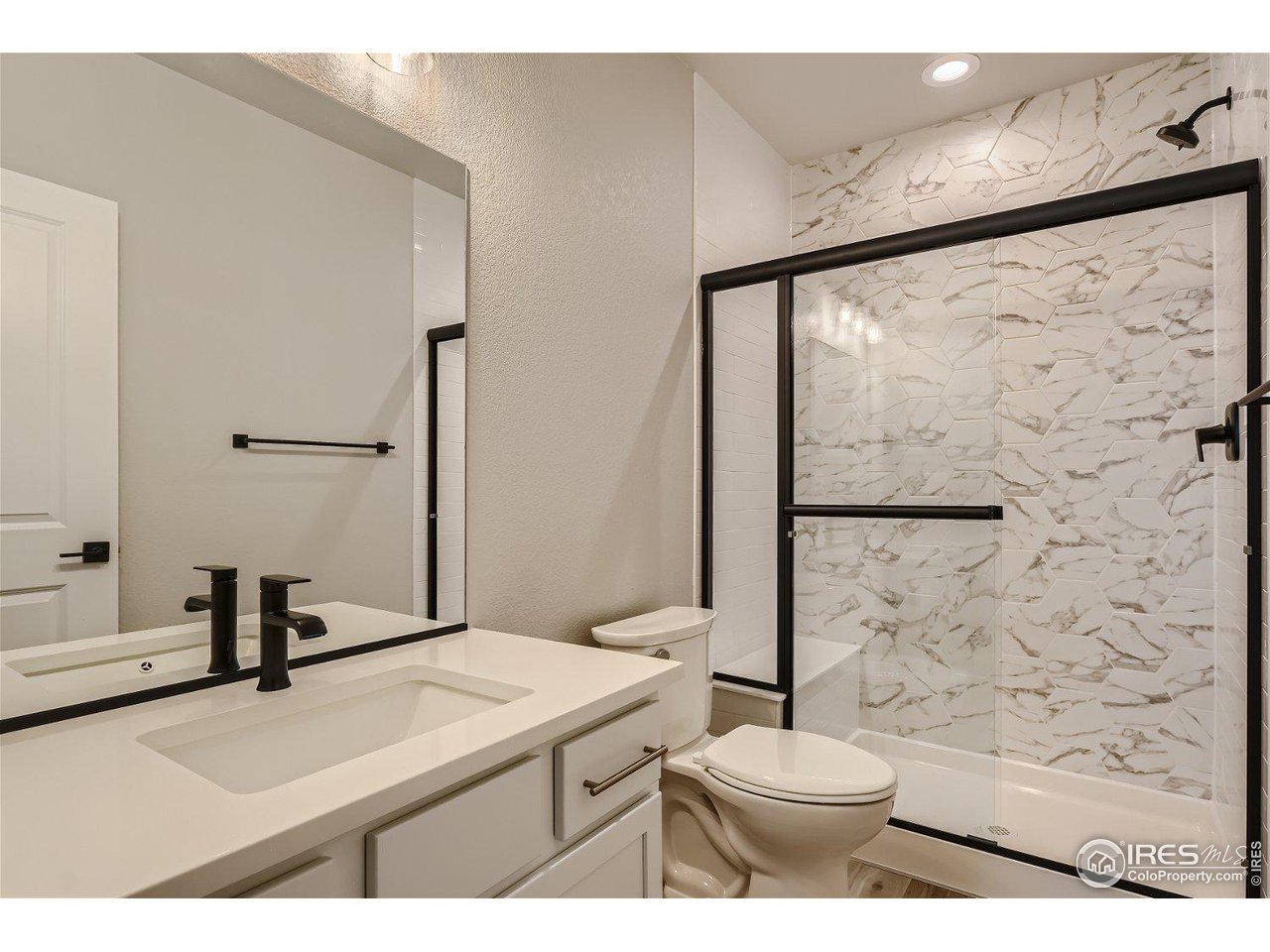822 Canoe Birch Drive Windsor, CO 80550 - Photo 12 of 14 a bathroom with a sink a toilet and a mirror