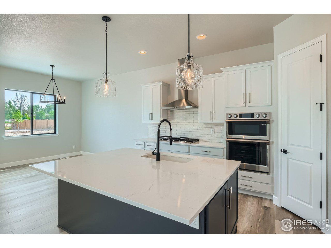 822 Canoe Birch Drive Windsor, CO 80550 - Photo 5 of 14 a kitchen with a sink a kitchen island and stainless steel appliances