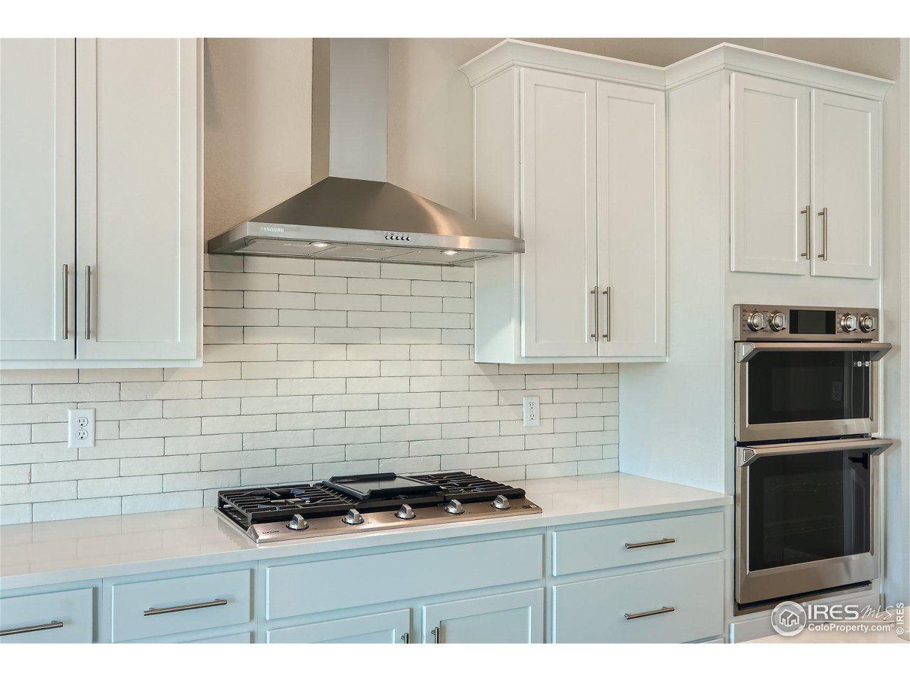 822 Canoe Birch Drive Windsor, CO 80550 - Photo 6 of 14 a kitchen with granite countertop a stove sink and cabinets