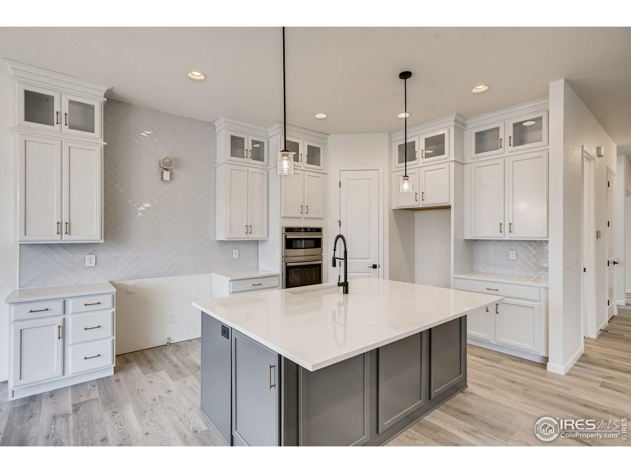 822 Canoe Birch Drive Windsor, CO 80550 - Photo 7 of 14 a kitchen with a sink a stove a refrigerator and white cabinets