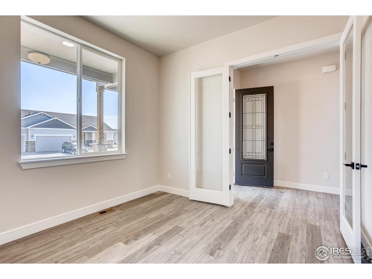 822 Canoe Birch Drive Windsor, CO 80550 - Photo 10 of 14 a view of an empty room with wooden floor and a window