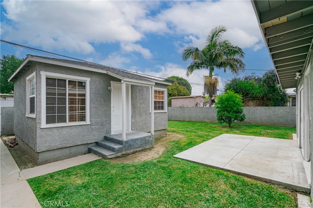 6786 Delta Avenue Long Beach, CA 90805 - Photo 12 of 16 a front view of a house with a yard and garage