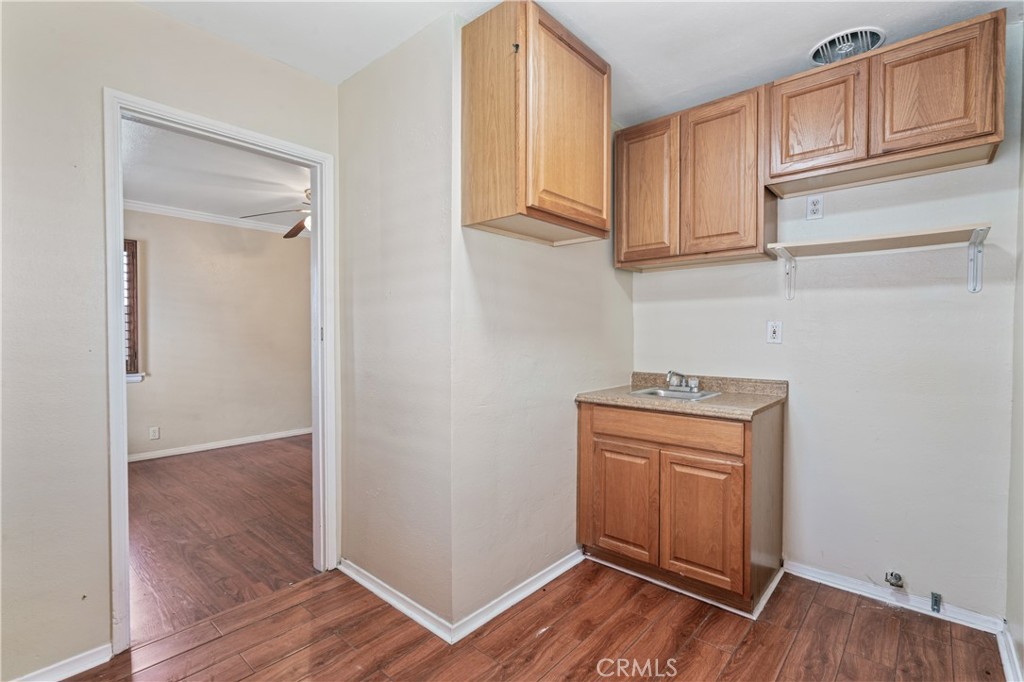 6786 Delta Avenue Long Beach, CA 90805 - Photo 14 of 16 a view of cabinets with wooden floor