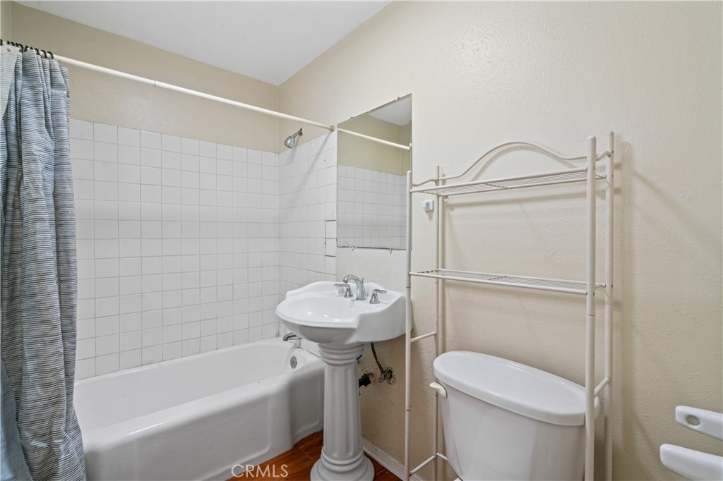 6786 Delta Avenue Long Beach, CA 90805 - Photo 15 of 16 a bathroom with a sink a toilet and shower