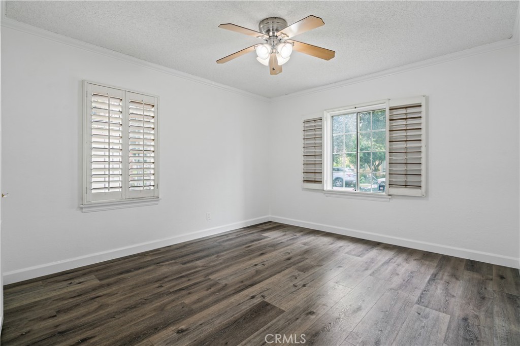 6786 Delta Avenue Long Beach, CA 90805 - Photo 3 of 16 a view of an empty room with wooden floor and a window
