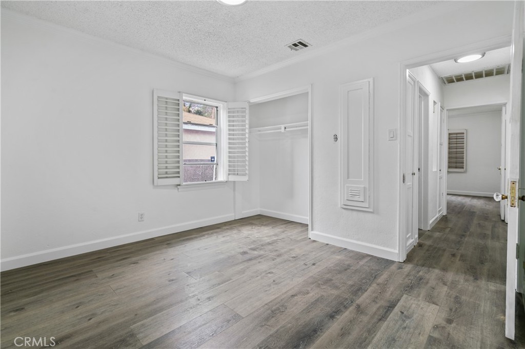 6786 Delta Avenue Long Beach, CA 90805 - Photo 4 of 16 a view of an empty room with wooden floor and a window