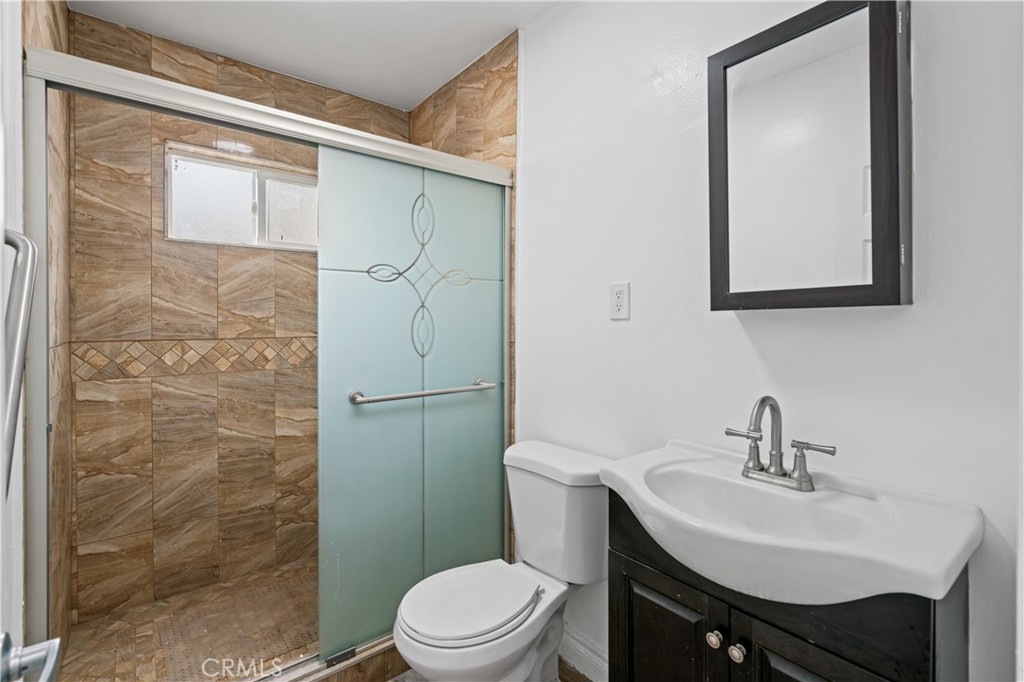6786 Delta Avenue Long Beach, CA 90805 - Photo 5 of 16 a bathroom with a sink a toilet and shower