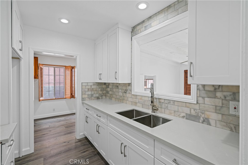 6786 Delta Avenue Long Beach, CA 90805 - Photo 6 of 16 a kitchen with a sink and cabinets