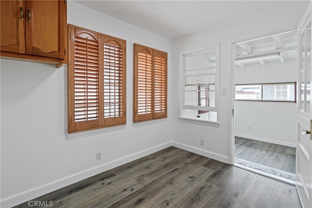 6786 Delta Avenue Long Beach, CA 90805 - Photo 7 of 16 an empty room with wooden floor and windows