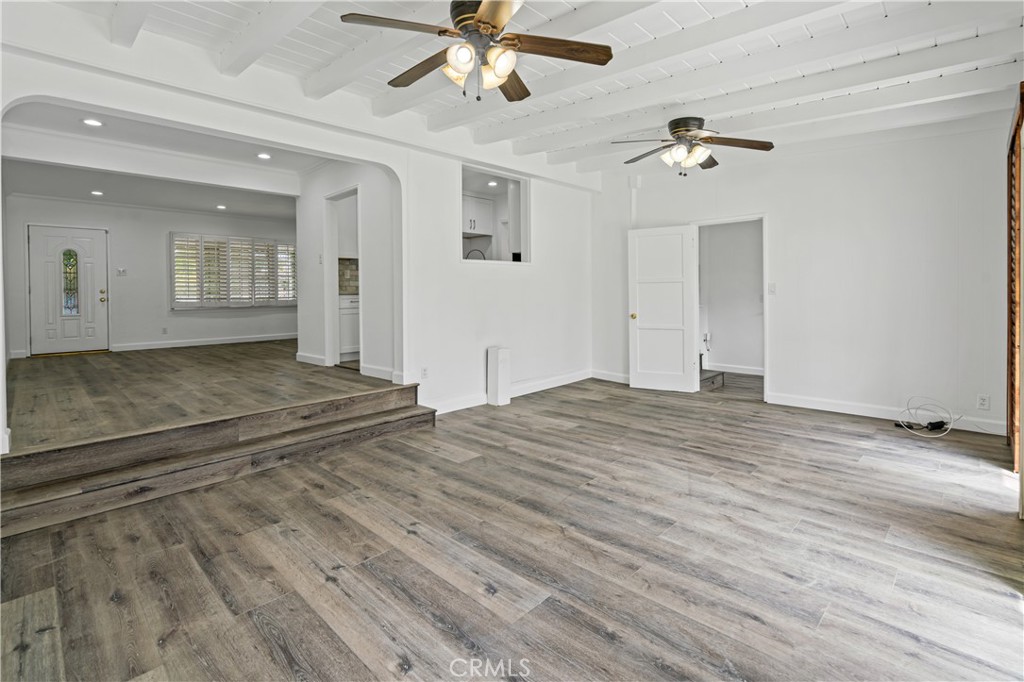 6786 Delta Avenue Long Beach, CA 90805 - Photo 10 of 16 a view of a livingroom with wooden floor and ceiling fan